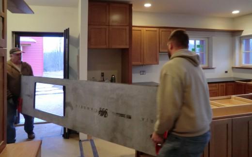 Counter top being carried in by Dustin and Don